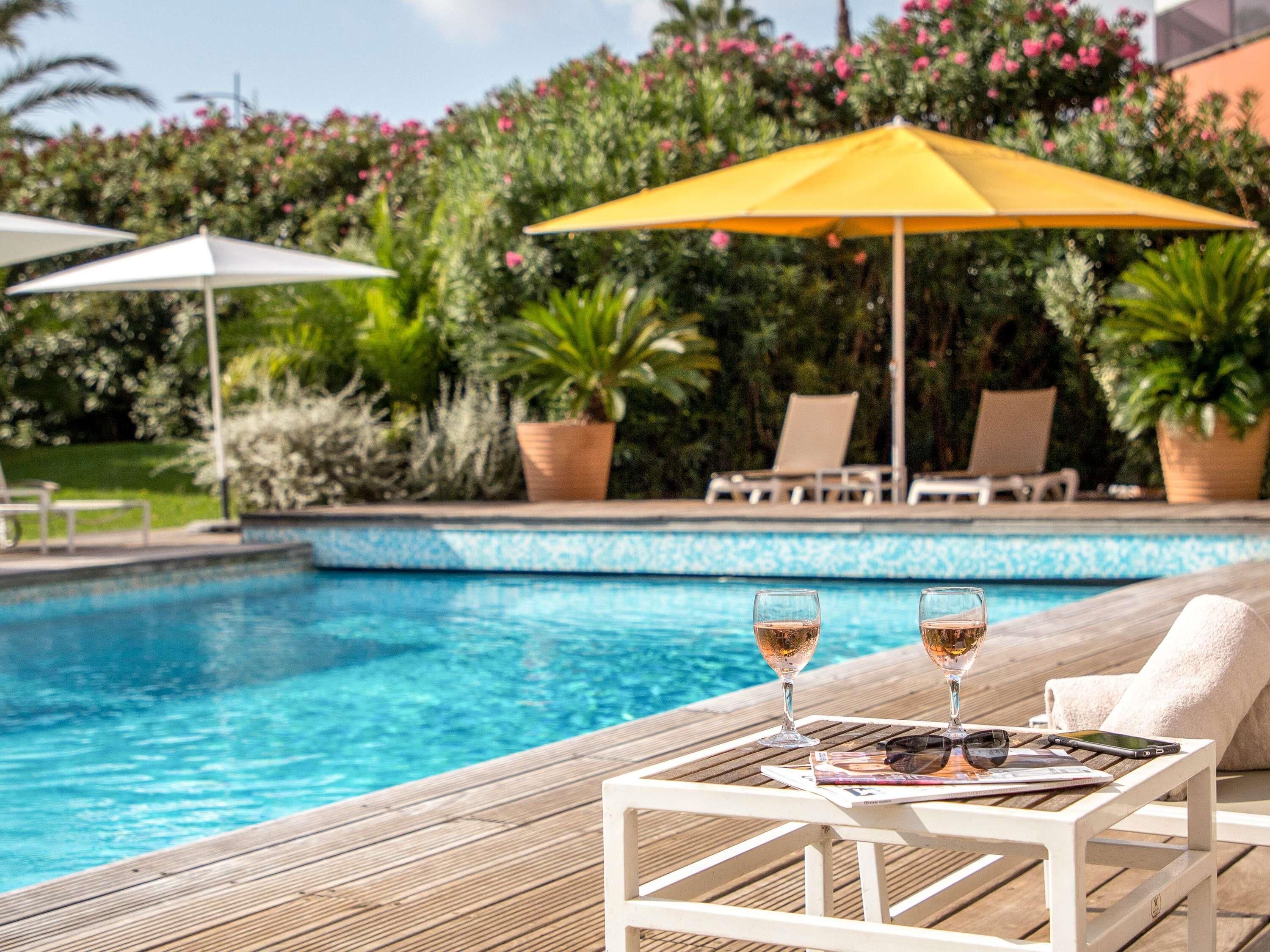 Seasonal outdoor pool, open 8:00 AM to 9:00 PM, pool umbrellas