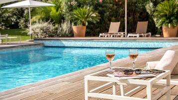 Seasonal outdoor pool, open 8:00 AM to 9:00 PM, pool umbrellas