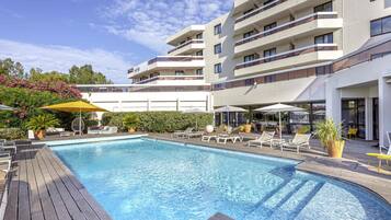 Seasonal outdoor pool, open 8:00 AM to 9:00 PM, pool umbrellas