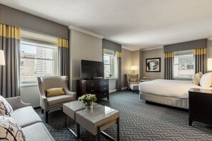 Relax in this stylish room with a large bed, flat-screen TV, and comfortable seating area.