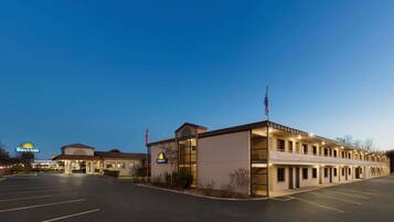 A Days Inn with a two-story building, a parking lot, and a clear sky.