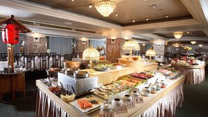 A buffet with various dishes and drinks, a chandelier, and traditional decor. - Golden China Hotel (Taipei)