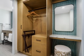 A bathroom with a wooden vanity, a mirror, and a towel rack. - DoubleTree Beach Resort by Hilton Tampa Bay - North Redingto (North Redington Beach)