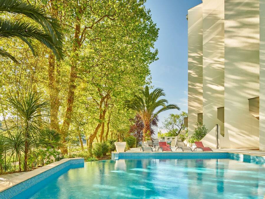 Seasonal outdoor pool, open 9:30 AM to 9:30 PM, pool umbrellas