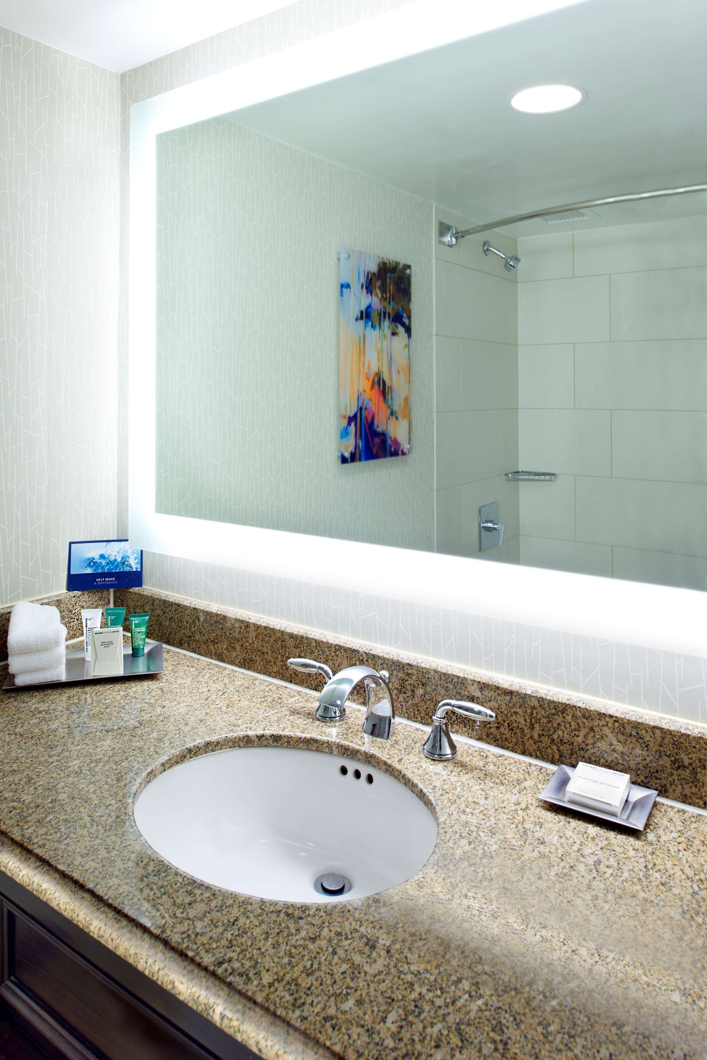 combined shower/bathtub, designer toiletries, hair dryer, towels