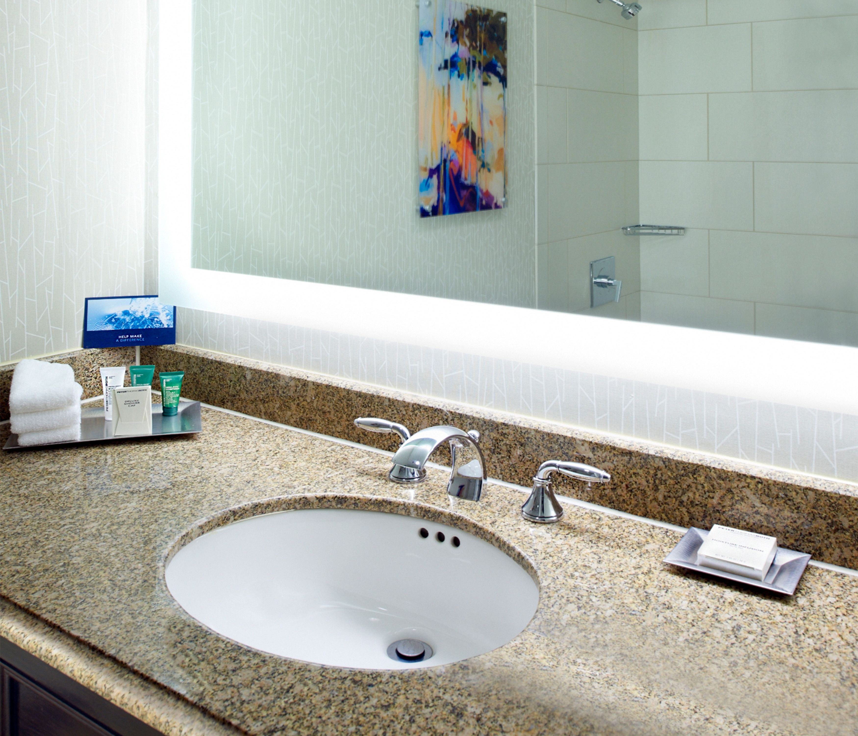 combined shower/bathtub, designer toiletries, hair dryer, towels