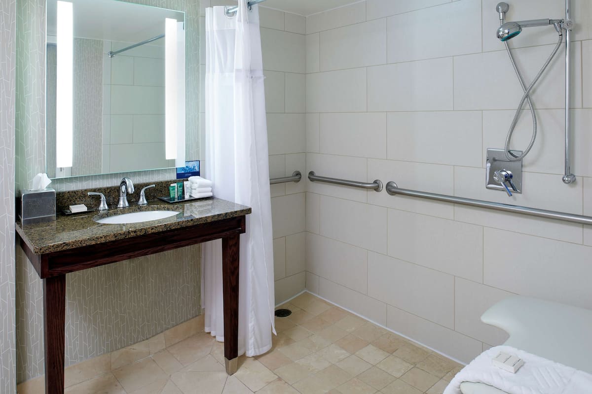room, 1 king bed, accessible (roll-in shower) | bathroom | combined shower/bathtub, designer toiletries, hair dryer, towels