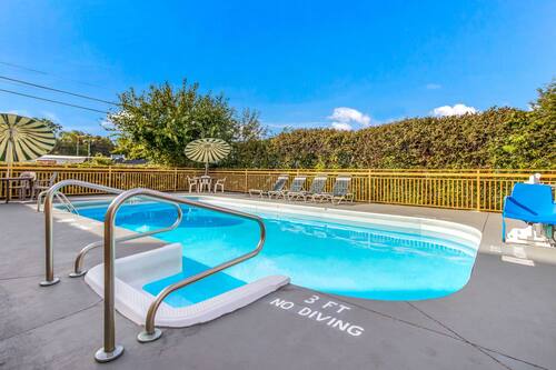 Seasonal outdoor pool, open 7:00 AM to 10:00 PM, pool umbrellas