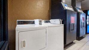 A row of washers and dryers in a commercial setting. - Super 8 by Wyndham Sandusky (Sandusky)