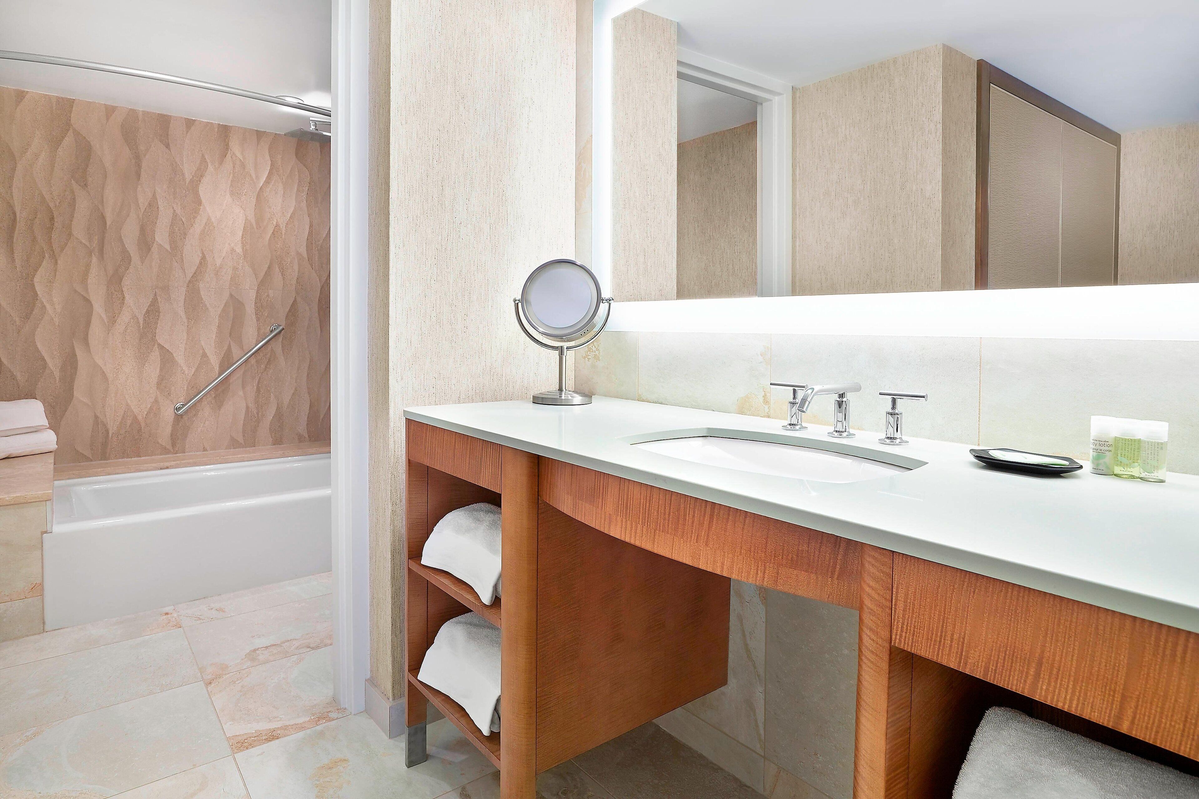 deluxe suite, 1 king bed | bathroom | combined shower/bathtub, designer toiletries, hair dryer, towels