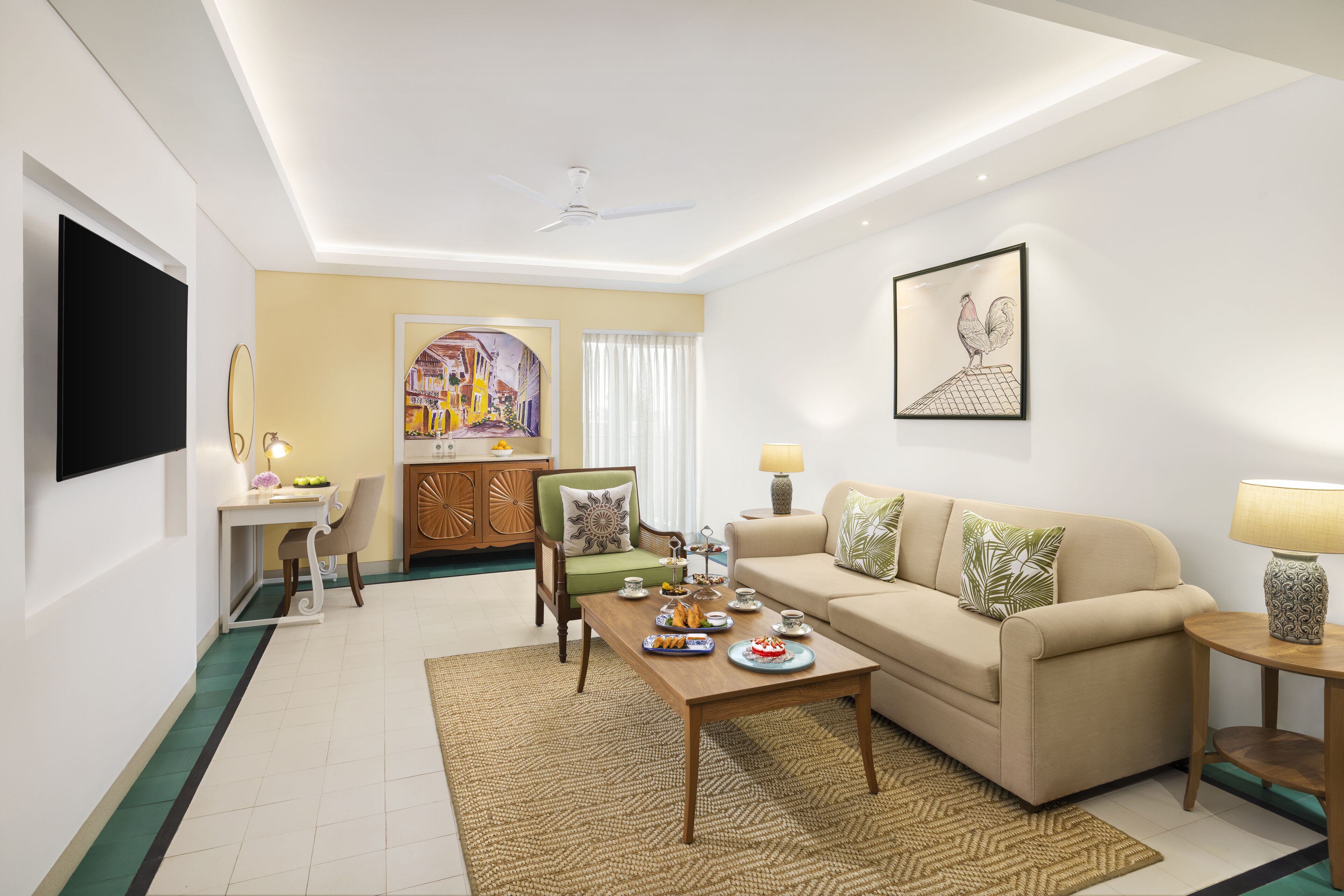 A modern living room with a sofa, coffee table, and a TV mounted on the wall.