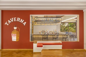 A bar area with a wooden floor, a bar counter with bottles and glasses, and a seating area with chairs and a bench.