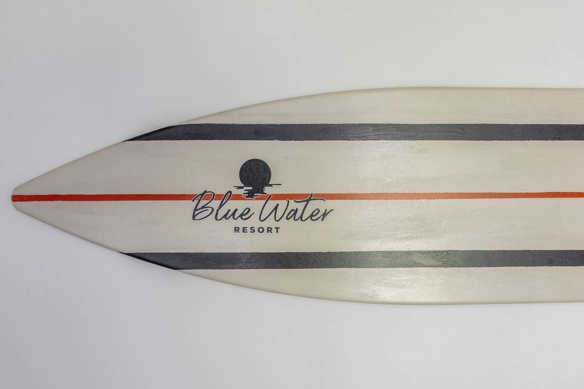 A surfboard with the text "Blue Water Resort" and a logo.