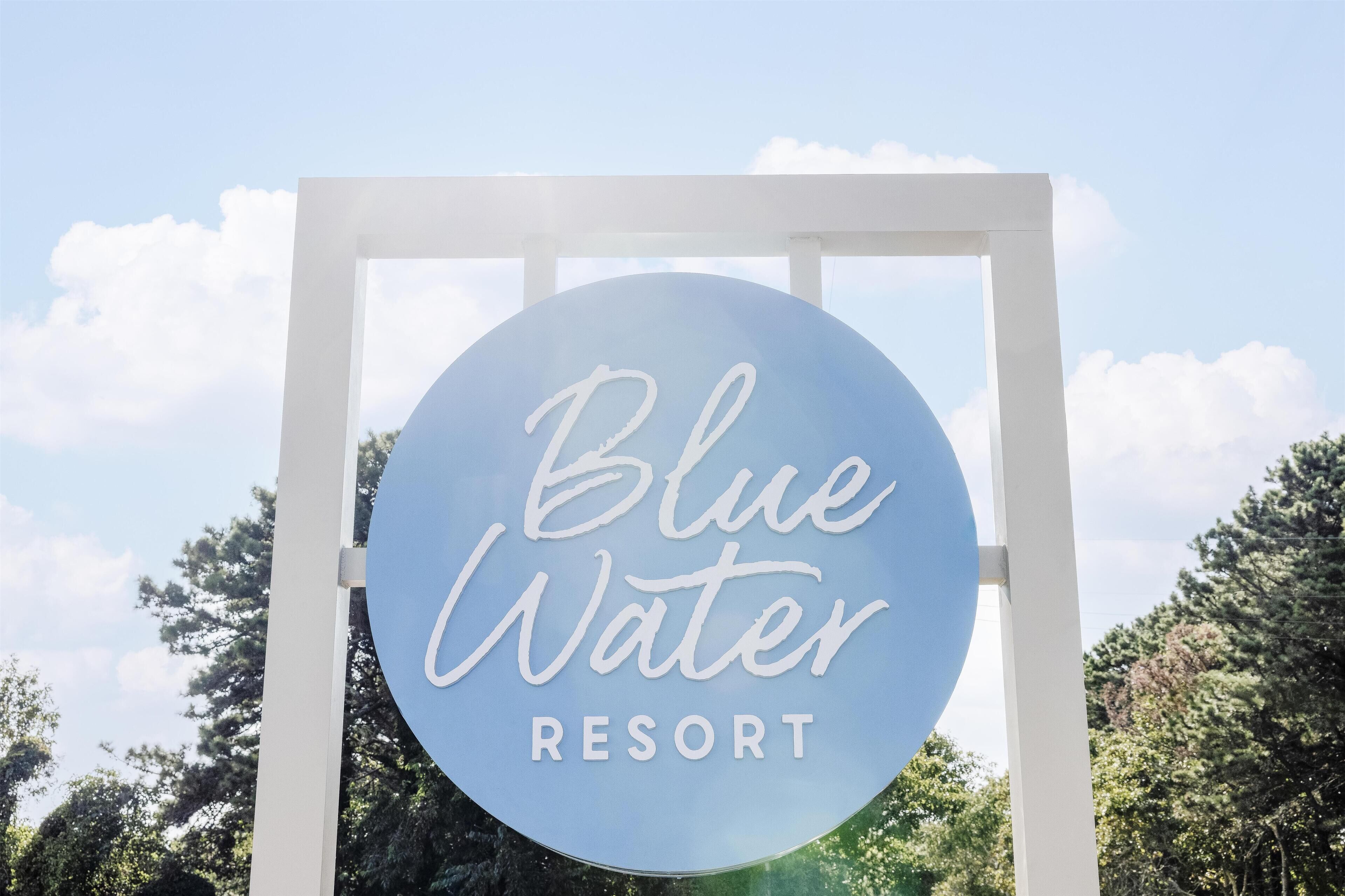 A sign for Blue Water Resort.