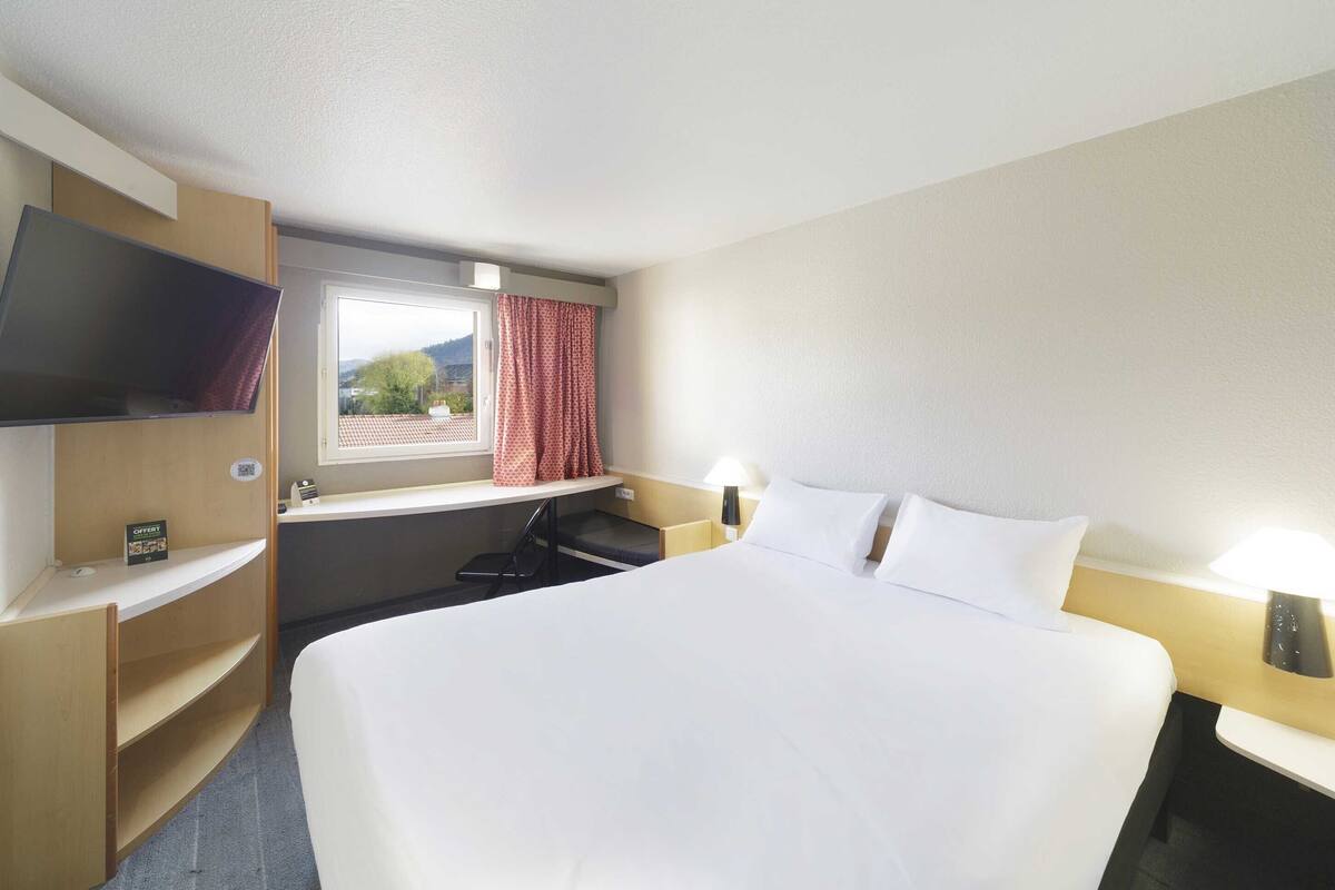 Premium bedding, desk, laptop workspace, blackout curtains
