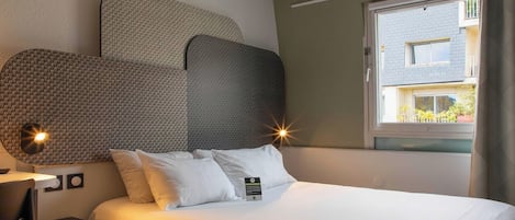 Premium bedding, desk, laptop workspace, blackout drapes