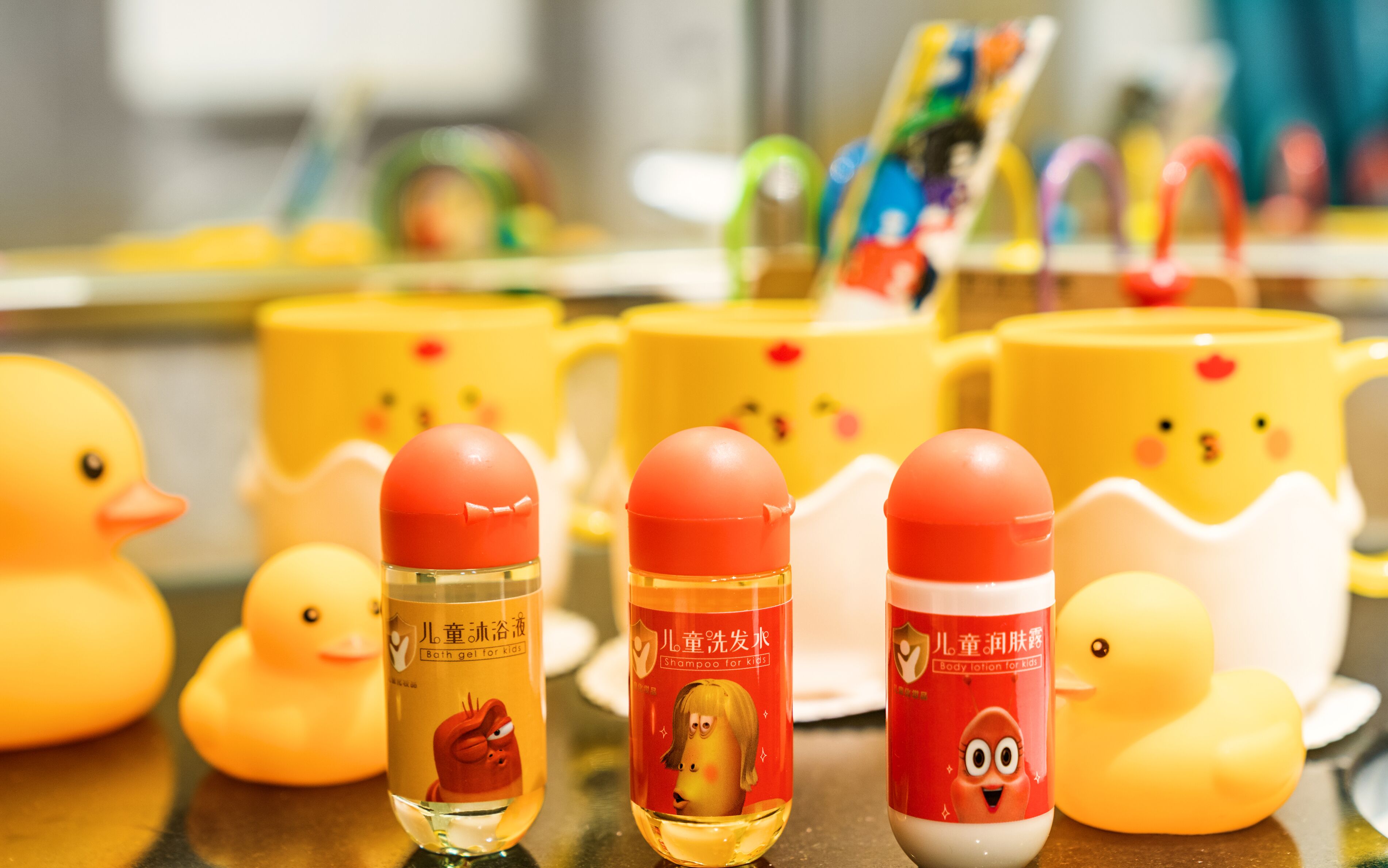 A variety of children's bath products, including bottles and cups, with cartoon characters on the labels.