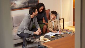Family fun awaits in this cozy space, where creativity flows with a couch, table, and plenty of playthings.