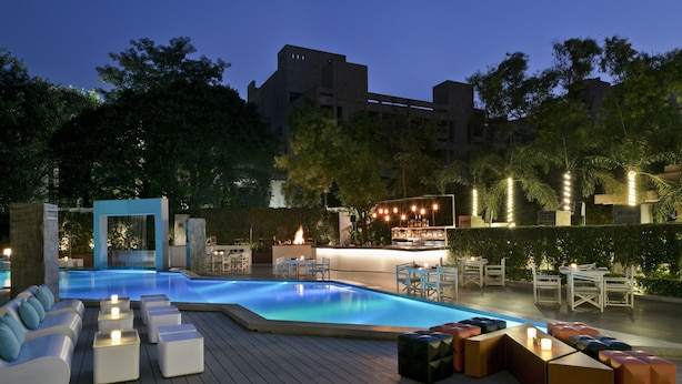A rooftop pool area with seating and a bar.