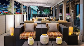 Relax in a, covered patio with comfortable sofas and ambient lanterns.