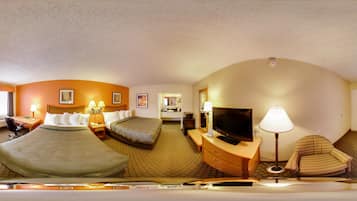 A hotel room with two beds, a TV, a desk, and a chair.
