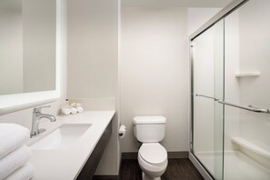 A modern bathroom with a white sink, toilet, and glass shower enclosure. - Holiday Inn Express & Suites Annapolis by IHG (Annapolis)