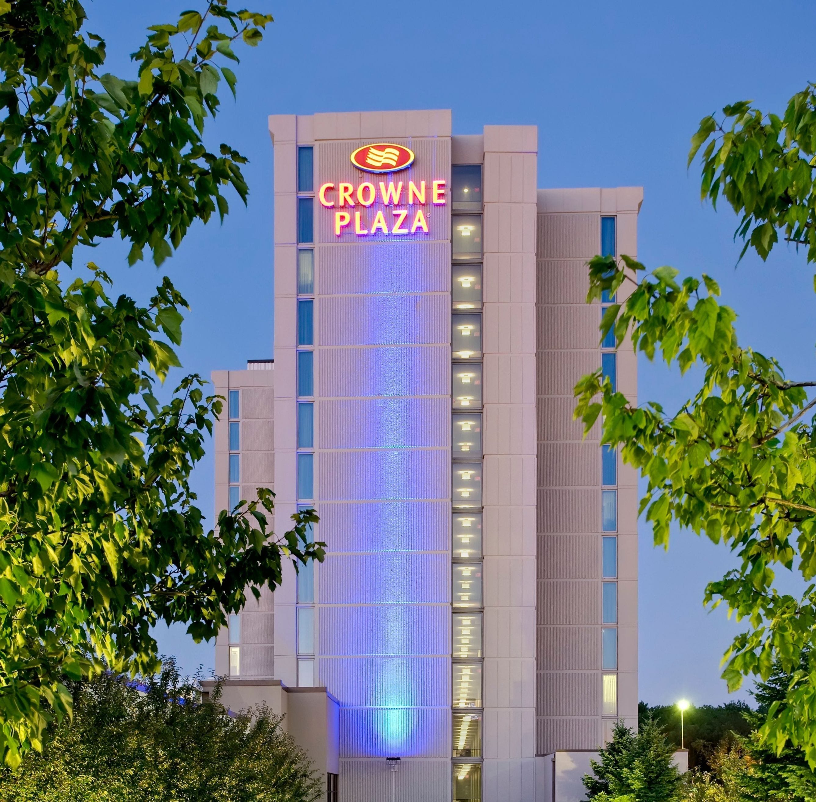 A hotel building with a prominent sign reading 'CROWNE PLAZA'.