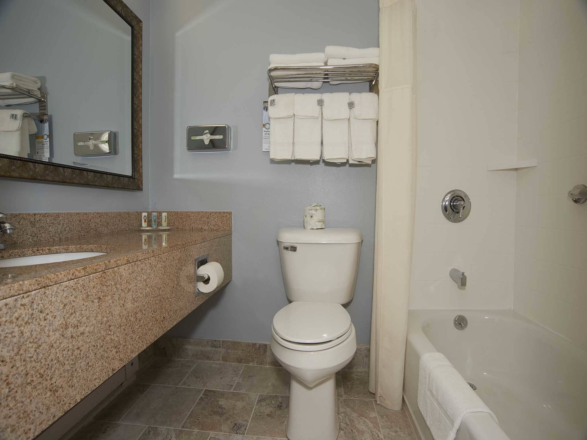 A bathroom with a sink, toilet, and bathtub.