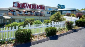 A two-story building with a 'Tavern' sign and a 'Quality Inn' sign. - Quality Inn Bourne - Cape Cod (Buzzards Bay)