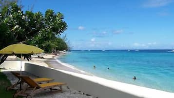 On the beach, white sand, sun loungers, beach umbrellas