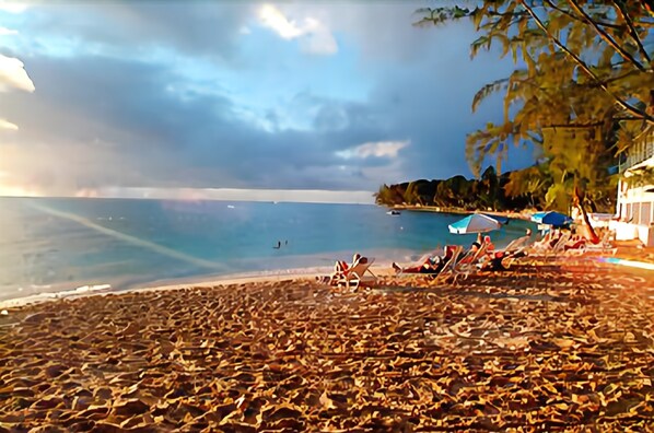 On the beach, white sand, sun-loungers, beach umbrellas