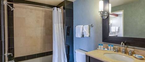 A bathroom with a bathtub, toilet, and sink.