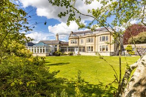 A large, historic building with multiple wings, a well-maintained lawn, and a variety of trees. - Leigh Park Country House Hotel & Vineyard, BW Signature Collection (Bradford-on-Avon)