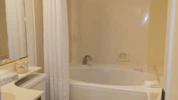 A bathroom with a toilet, sink, and bathtub.