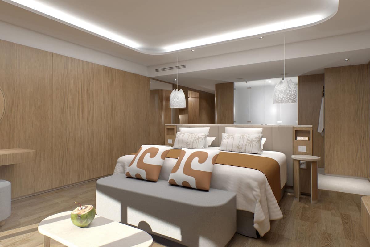 A modern hotel room with a large bed, a bedside table, a small seating area, and a large mirror.