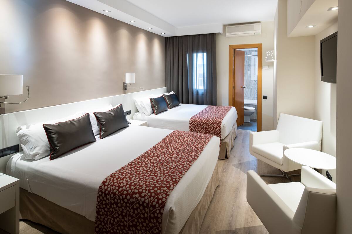 Family Room (2 adults + 2 children) | Minibar, in-room safe, desk, blackout drapes