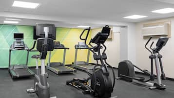A gym with treadmills, elliptical machines, and stationary bikes.