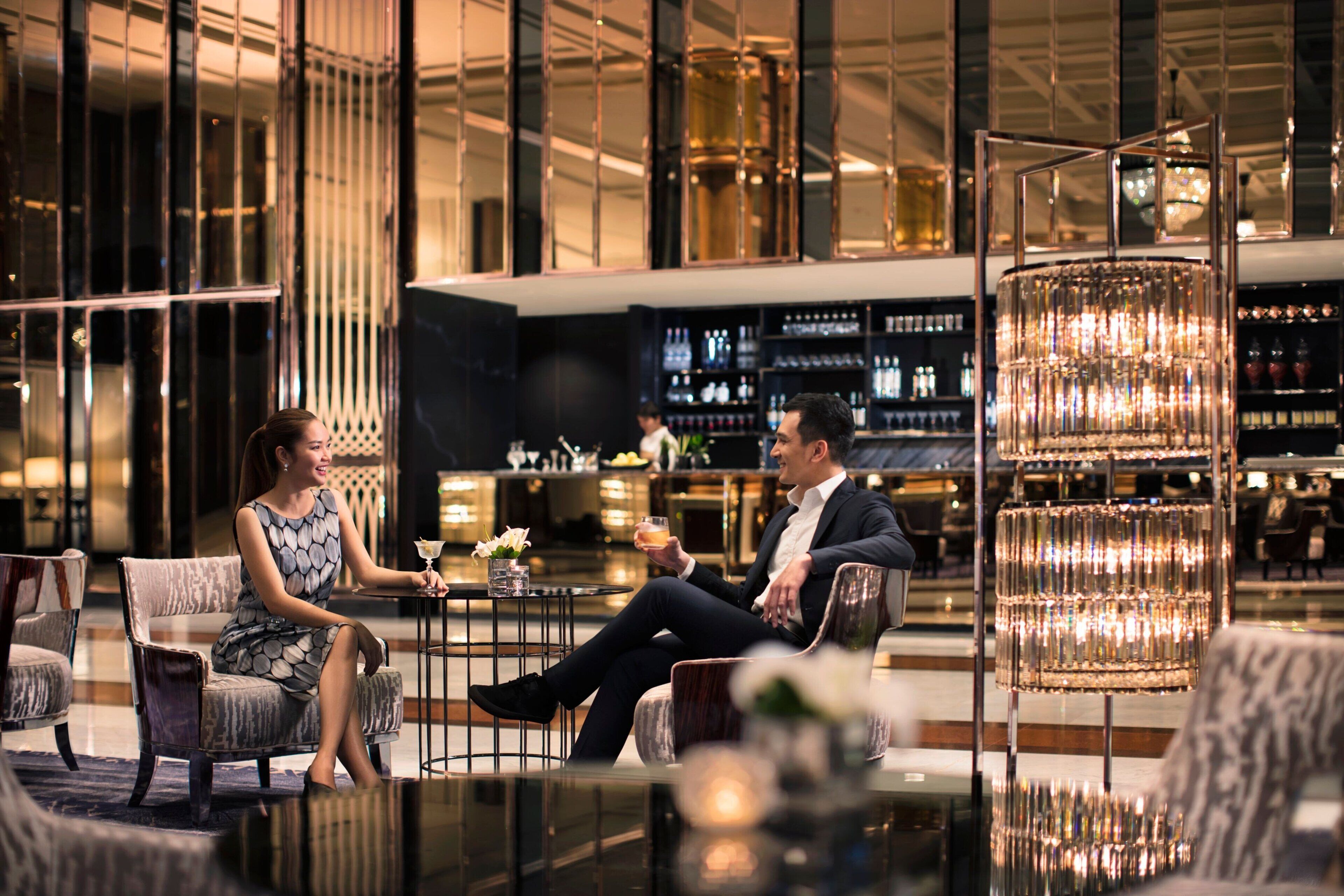 A modern bar area with seating and a bar counter.