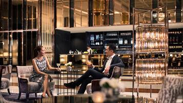 A modern bar area with seating and a bar counter.