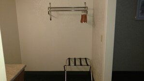 A bathroom with a towel rack, a small stool, and a towel rack with towels. - Keystone Boardwalk Inn and Suites (Keystone)