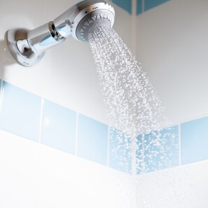 A showerhead with water flowing down.