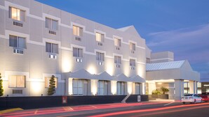 A modern hotel with a symmetrical facade, multiple windows, and a covered entrance area. - Casa Grande Delicias (Delicias)