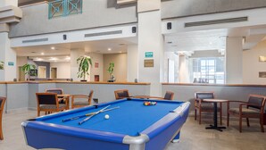A pool table in a spacious indoor area with multiple levels and seating arrangements. - Casa Grande Delicias (Delicias)
