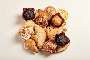 A variety of pastries and bread on a plate.