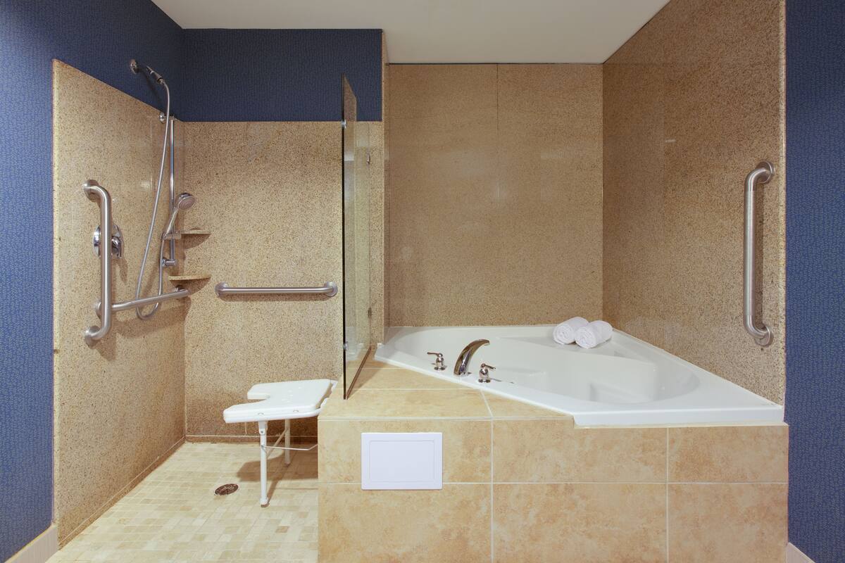 separate bathtub and shower, hair dryer, towels