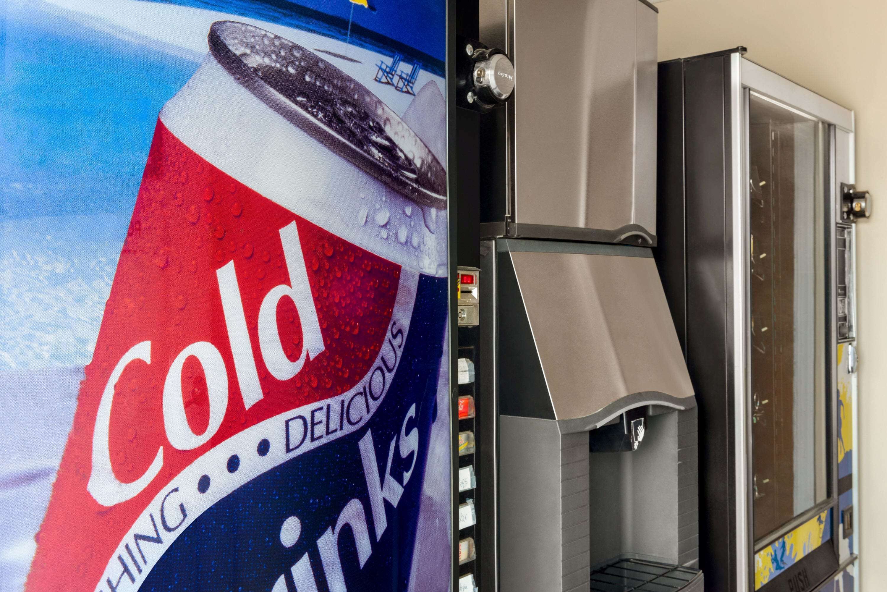 A vending machine with a large Coca-Cola advertisement.