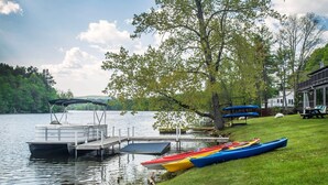 A lakeside dock with kayaks and a covered boat ramp. - The Black Swan Lee - Lenox, an Ascend Collection Hotel (Lee)