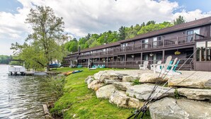 A lakeside lodge with a dock, fishing rods, and outdoor seating. - The Black Swan Lee - Lenox, an Ascend Collection Hotel (Lee)