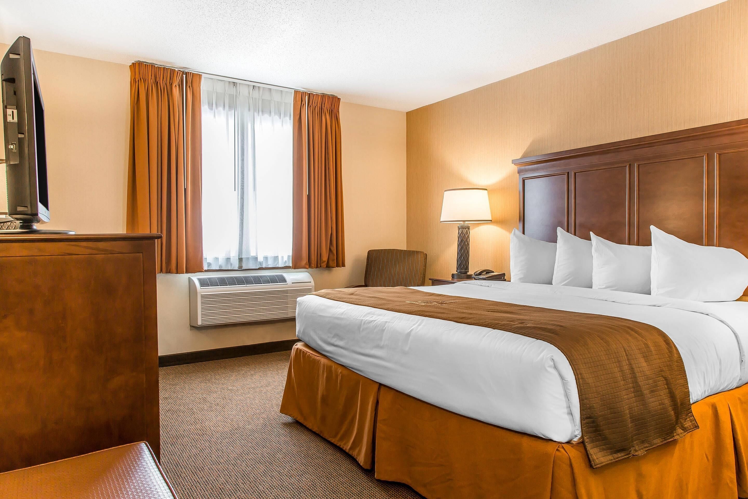 Premium bedding, desk, laptop workspace, blackout curtains