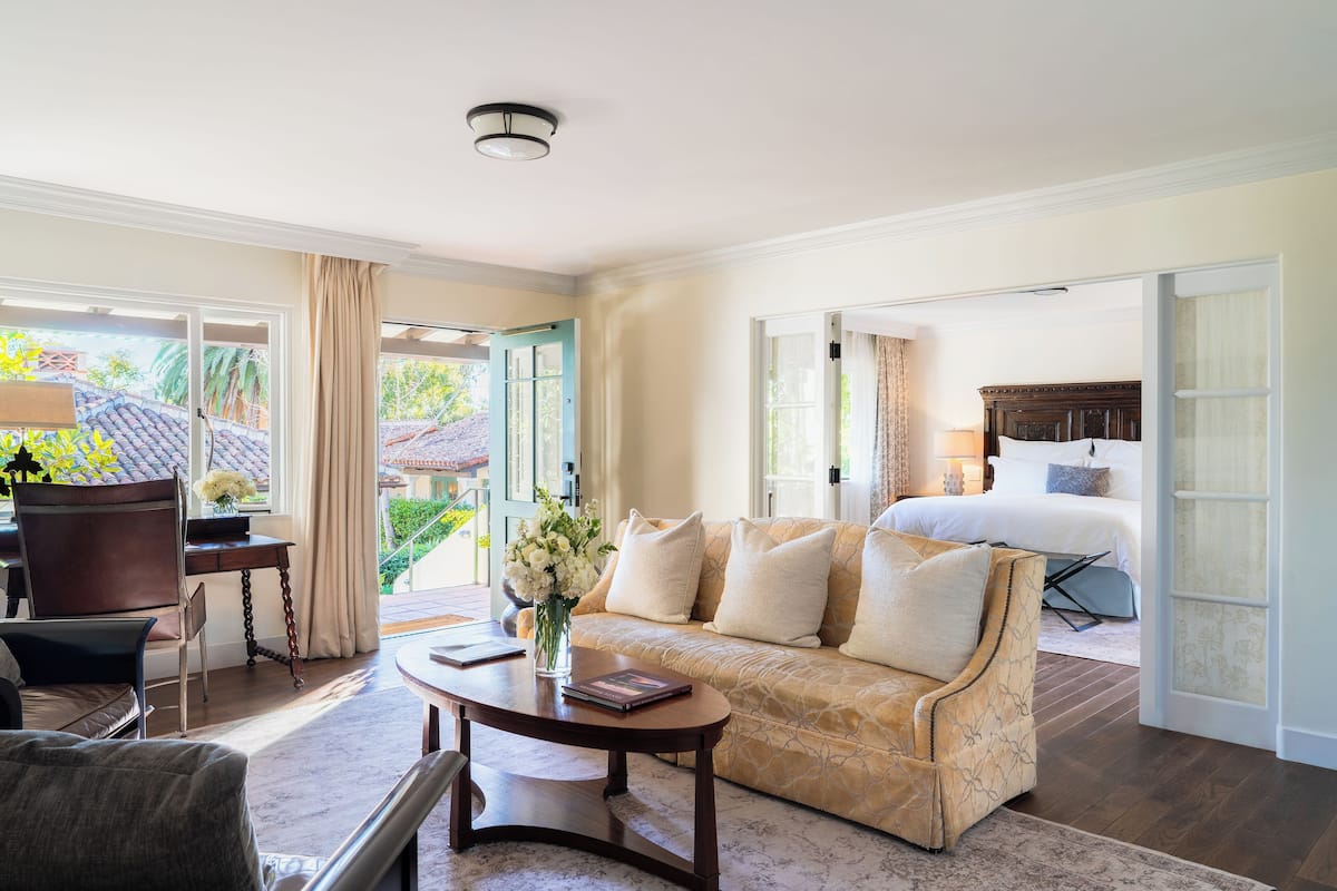A spacious living area with a sofa, coffee table, and a view of the outdoors.
